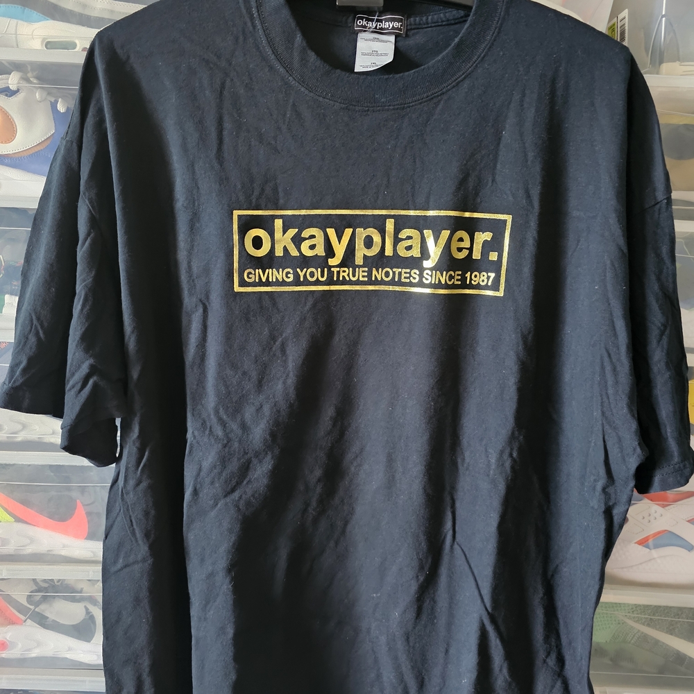 The Roots Okayplayer Black T-Shirt with Gold Logo